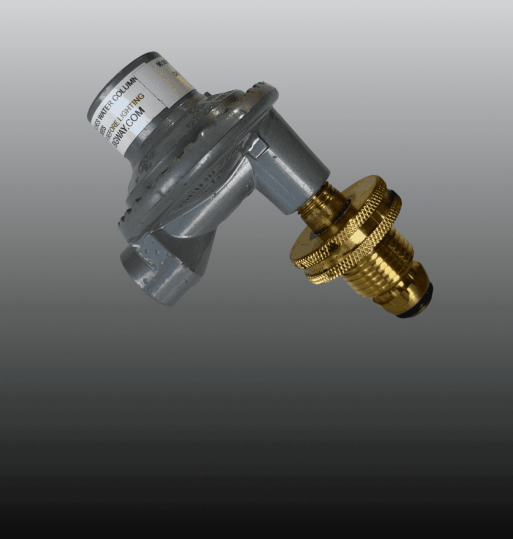 Close-up of a mechanical valve with a brass fitting and a gray body.
