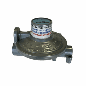 A metal gas regulator with warning labels and connection ports.
