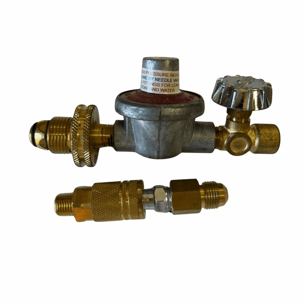 Gas regulator with attached valve and fittings against a dark background.