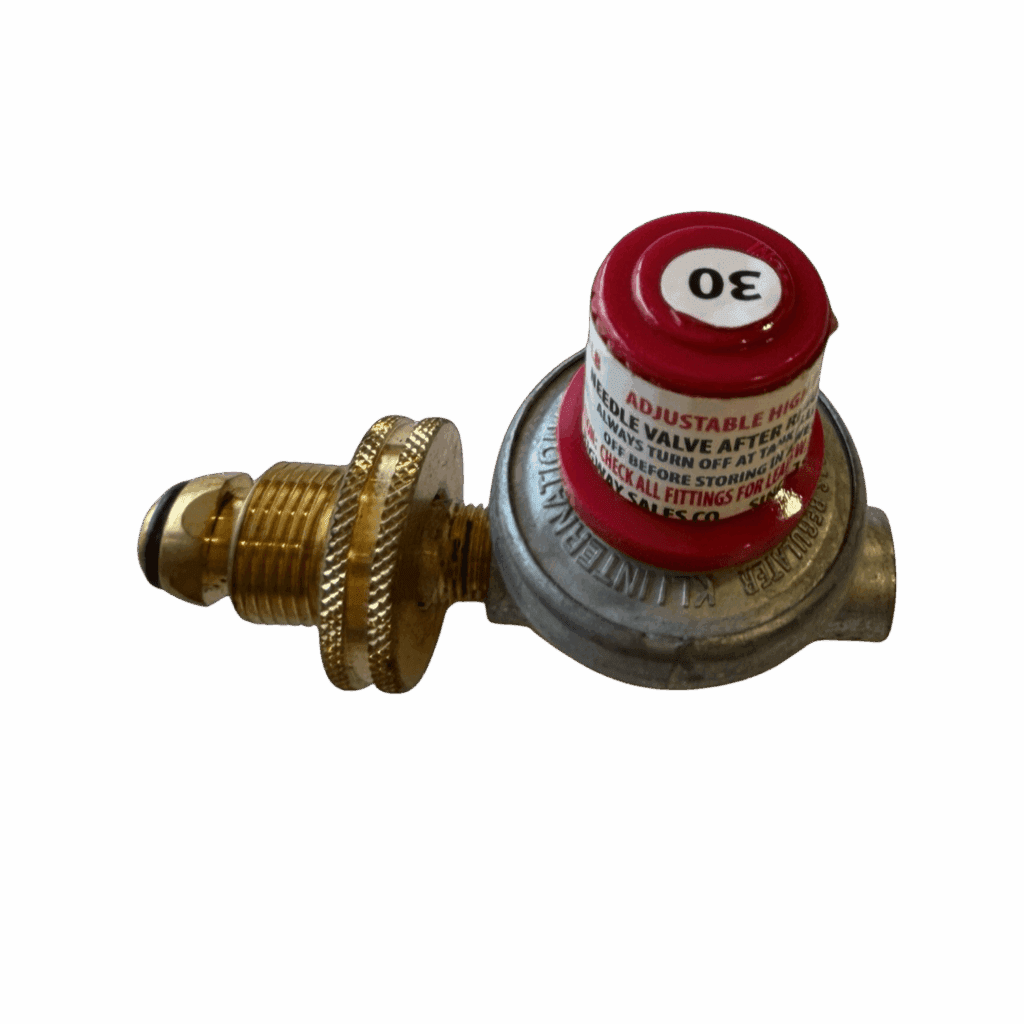 Close-up of a metallic gas regulator with a red dial and brass fittings.