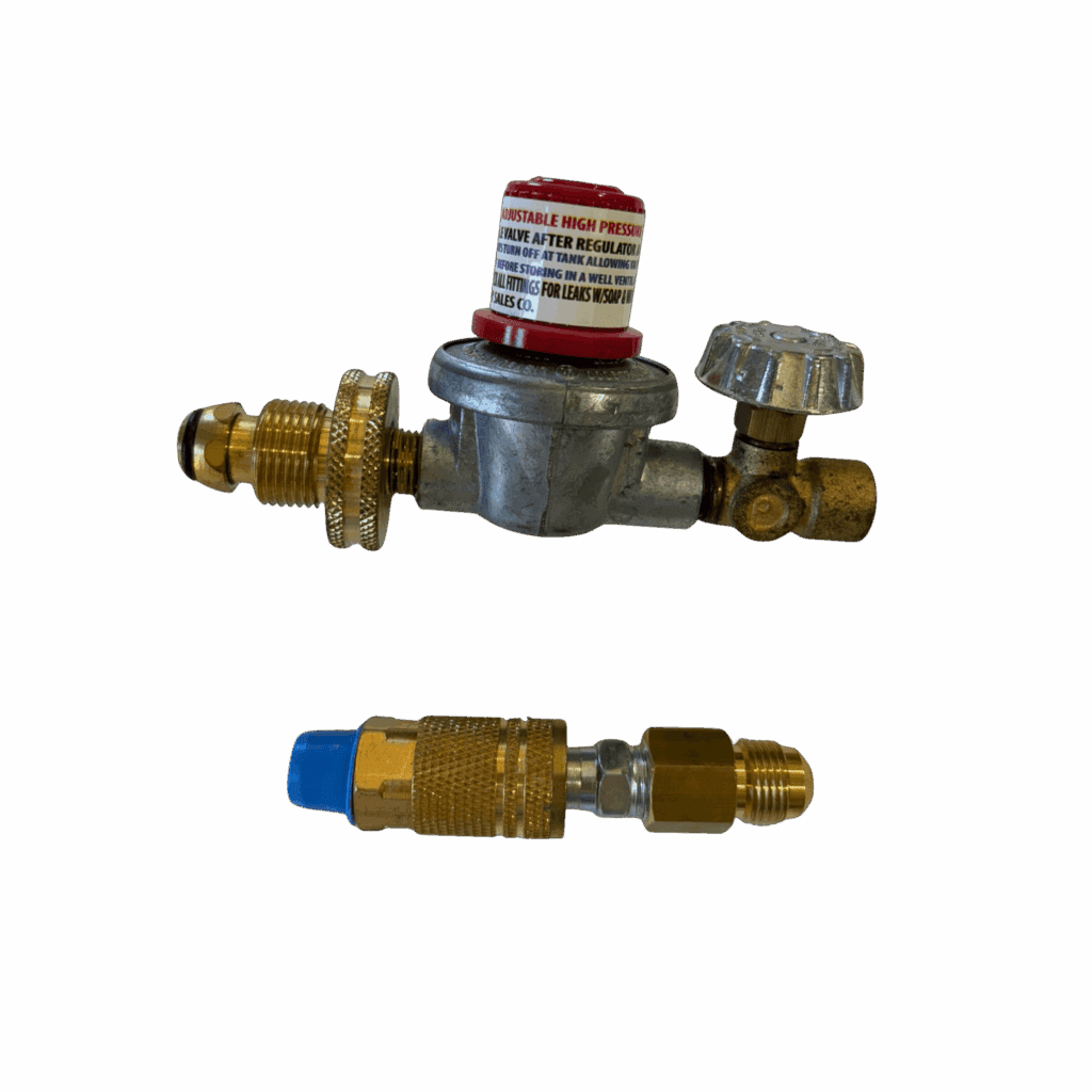 Three brass plumbing fittings and a valve arranged on a surface.