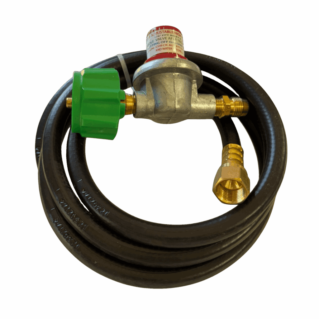 Coiled black hose with brass and green valve fittings on a beige surface.