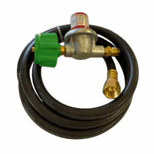 Coiled black hose with brass and green valve fittings on a beige surface.