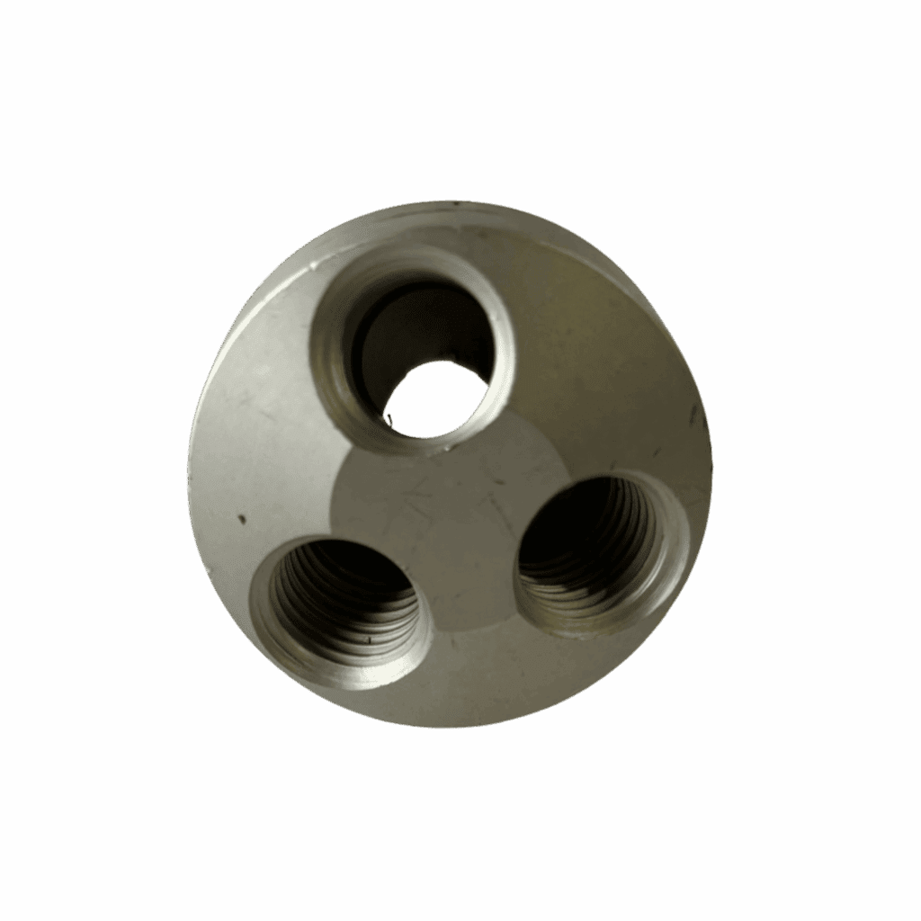 A metallic cylindrical object with three circular holes arranged in a triangular pattern.