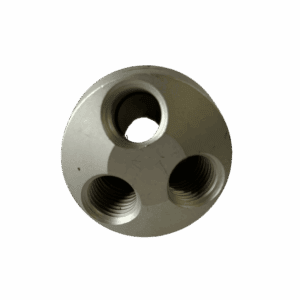A metallic cylindrical object with three circular holes arranged in a triangular pattern.
